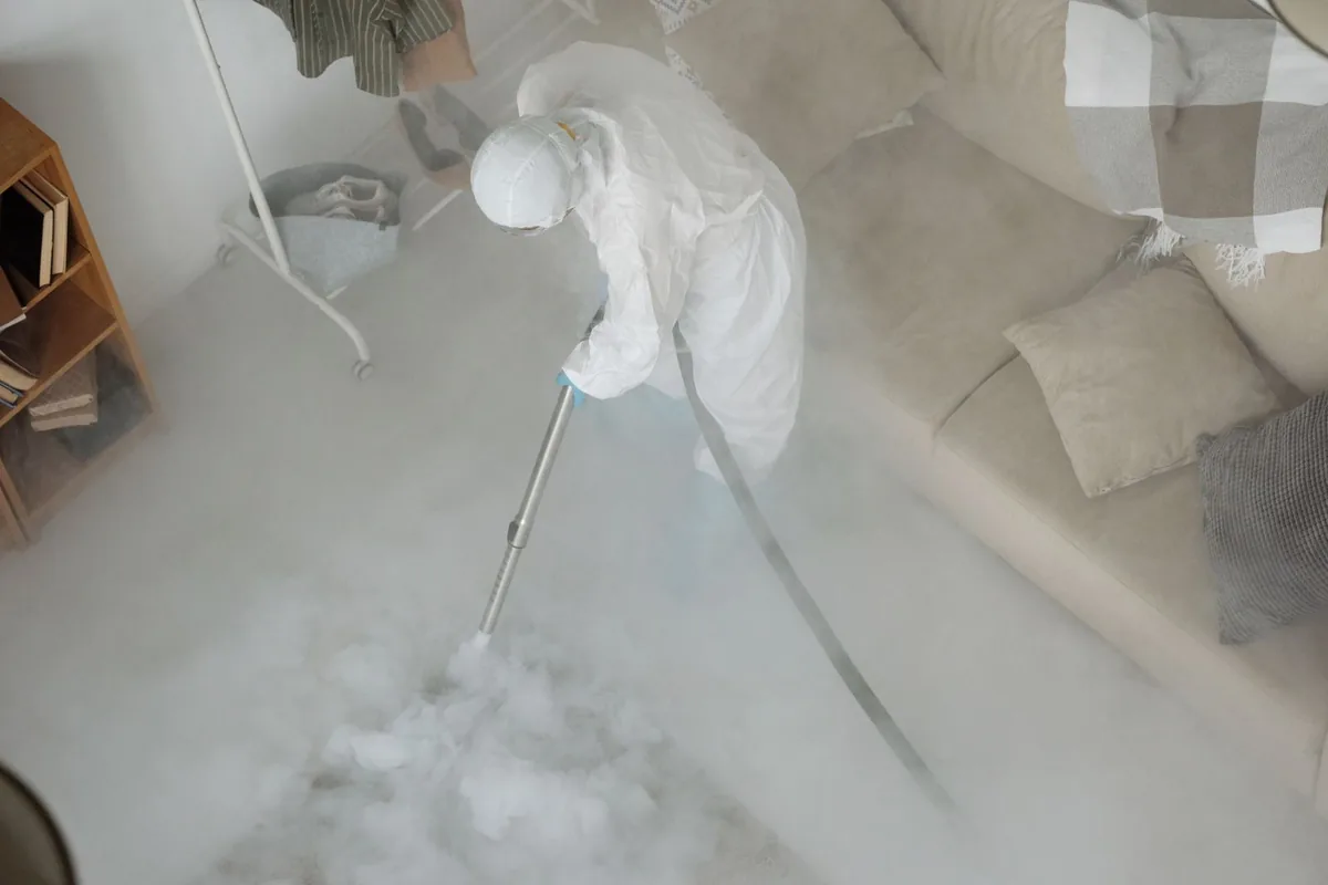 Biohazard cleanup technician in protective equipment, Pilgrim Village, Detroit, MI